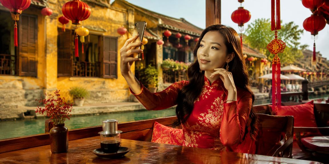 Người chơi Hội An kiểm tra thông tin giao dịch rút tiền khi ngồi cà phê